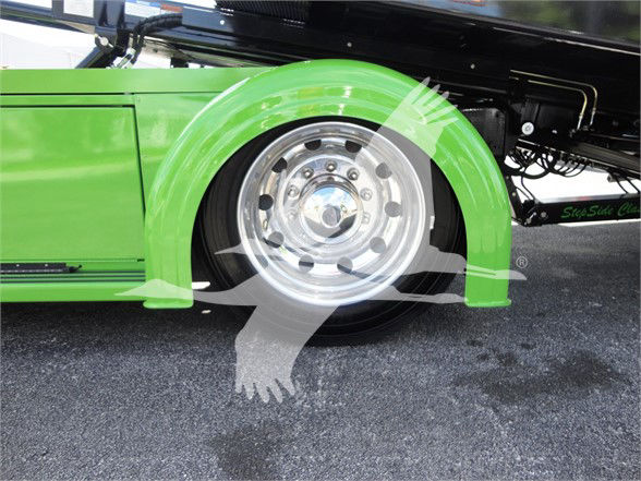 Green Peterbilt 337 truck showing front wheel well and chrome wheel.