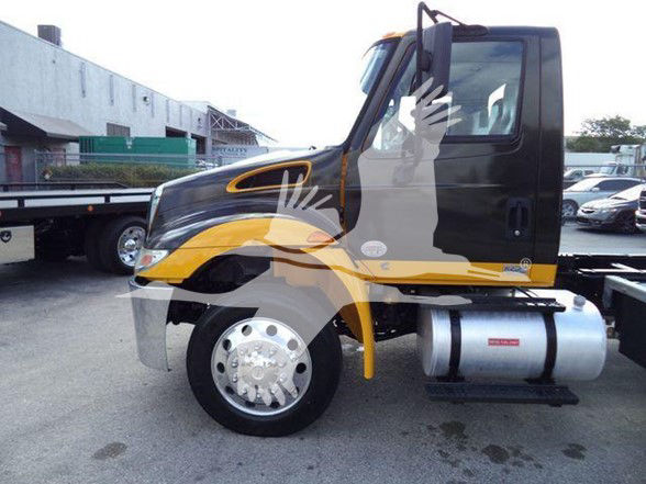 Truck engine bay area not visible; side view of 2019 International DURASTAR 4300 cab with black and yellow livery, single rear axle, fuel tank mounted under cab.