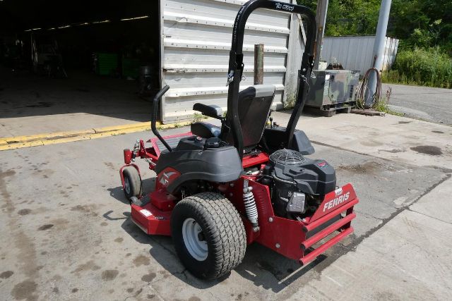 Ferris IS 700Z zero-turn mower with black roll bar, red deck housing, and black engine cover; large rear tire and front wheel, operator seat, in an outdoor lot.