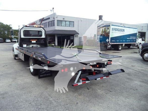 2019 Peterbilt 337 tow truck rear view showing flatbed and rear bumper with safety lights.