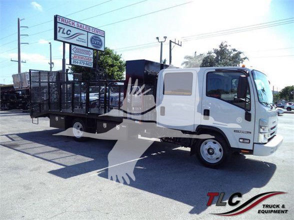 Isuzu NPR HD landscape truck with flatbed and toolbox, seen from the passenger side, TLC Truck & Equipment logo visible.