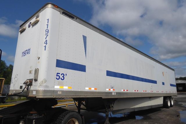 Great Dane trailer 53' seen from side and rear showing 119741 and 53' markings, blue graphics, and tandem axle setup.