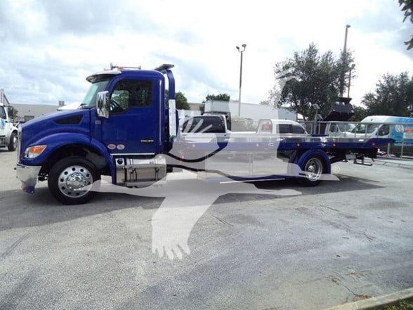 Kenworth T280 tow truck in blue, side view showing cab and long flatbed.