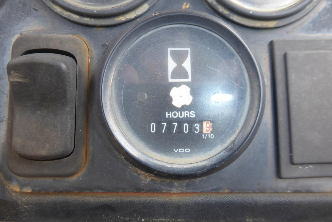 John Deere hour meter showing 77039 hours on a tractor dashboard with VDO logo and an hourglass icon.