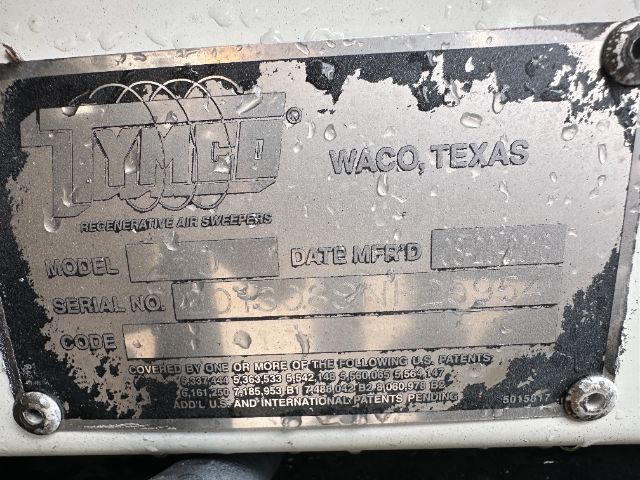 Isuzu Ta Mark plate on sweeper chassis showing TYMC? logo, Waco, Texas, model/serial/code fields and date etc. Fender plate with dirt and screws.