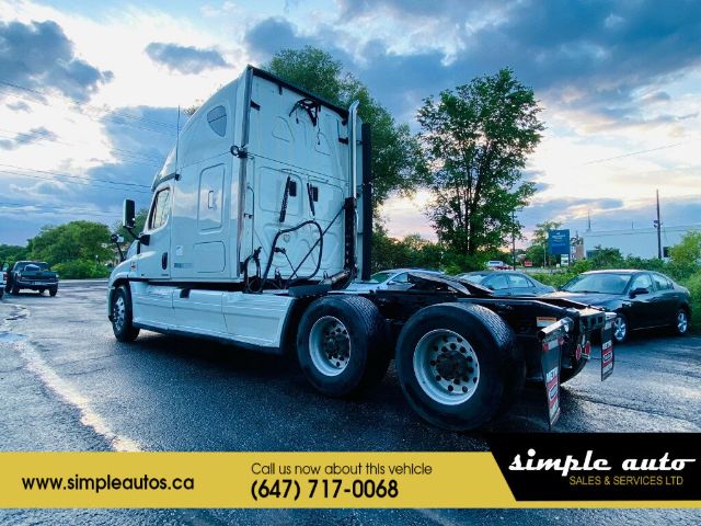 2012 Freightliner Cascadia truck cab with twin rear axles in a used lot. Visible text: VIN 1FUJGLDR2CSBK0204, Stock Number 0204, Category Truck and Trailer, Type Trucks, NewUsed Used. Banner shows simple autos website and phone number (647)