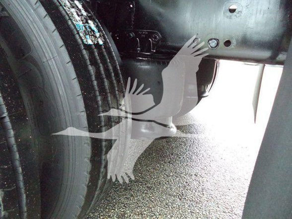 Truck wheel and undercarriage area of a Freightliner M2 106 showing tire and frame components.