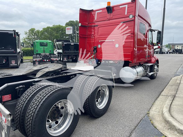 Volvo VNL64T740 tractor cab with red sleeper, dual rear axles, visible fuel tanks, and chrome wheels; SVIN 4V4NC9EH0NN289010 visible in listing context.