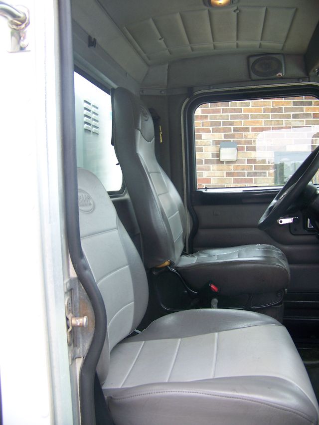 Peterbilt 335 truck cab interior showing front seats and dashboard area