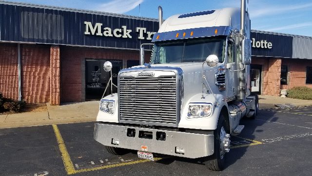 Truck cab front view of a 2013 Freightliner Coronado 132 with chrome grille and large bumper.