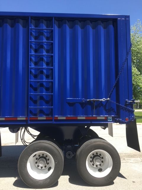 Blue 40 ft square dump trailer with dual tandem wheels and a chained tailgate.
