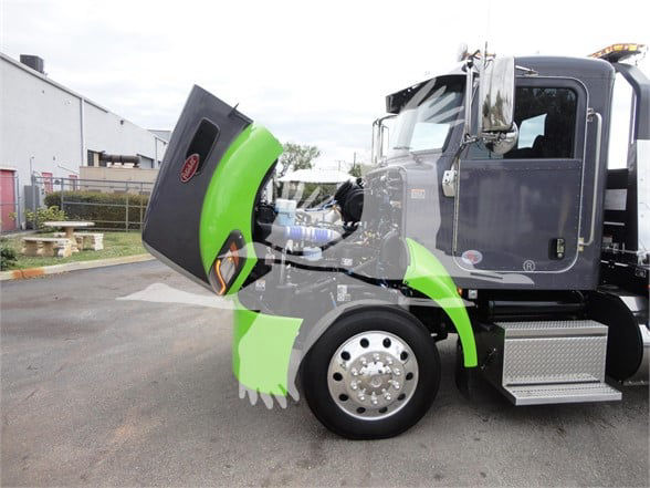 Peterbilt 337 truck side view with hood open revealing engine area and front wheel; green service hood visible