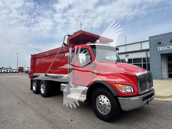 Kenworth T480 dump truck in red with aluminum side panels and three rear axles, front grille and bumper visible, dealership lot in background.