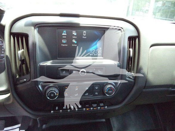 Dashboard touchscreen with grid icons, central console controls, and climate controls inside a pickup truck cab.