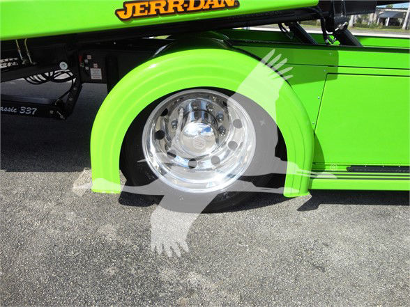 Truck wheel and bright green fender with 'JERR-DAN' branding visible on the side of the Peterbilt 337 tow truck.