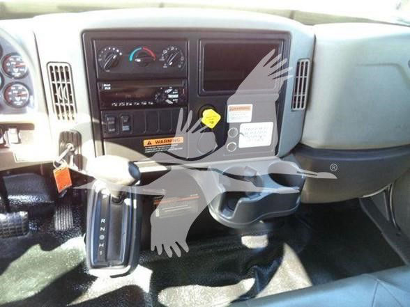 Dashboard and gear selector of a 2019 International DURASTAR 4300 truck interior showing steering column, instrument cluster, climate controls, and center console.