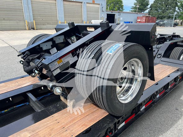 XL Specialized Xl22Fa trailer on lowboy with dual rear tires and wooden deck, side scuff and metal frame visible.