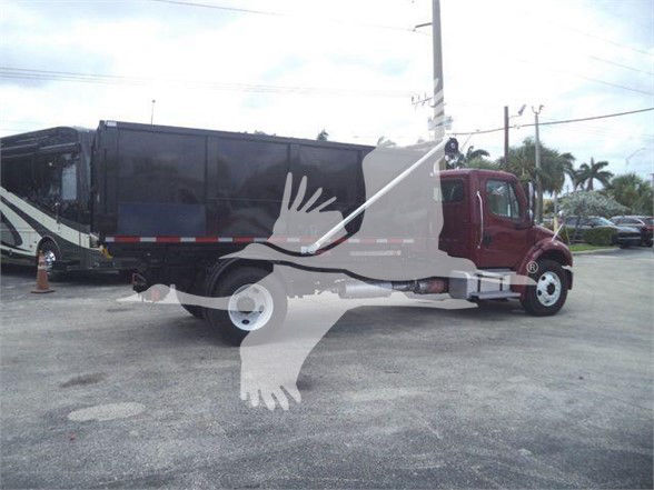 2015 Freightliner BUSINESS CLASS M2 106 truck with a red front cab and black refuse body; watermark of a turtle-like graphic overlays the image.