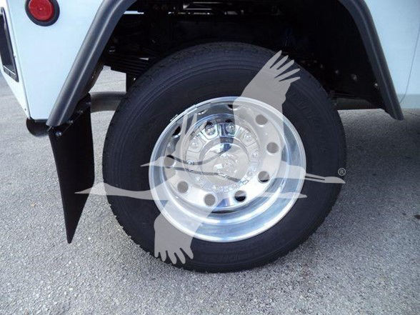 Ram 5500 wheel and tire with polished chrome hubcap and black fender flare.
