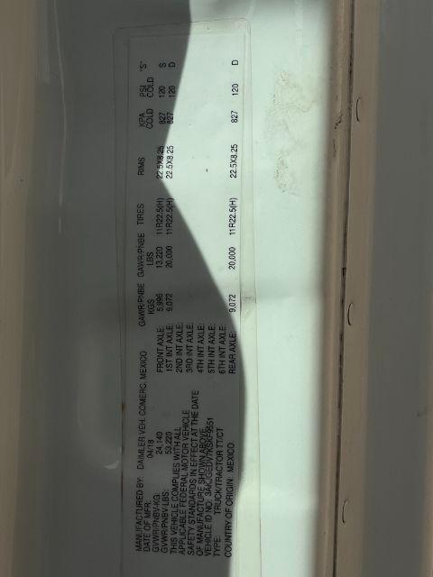 Label inside Freightliner Cascadia truck door with tire and axle information, including GVWR and tire specifications (text is small and vertical).