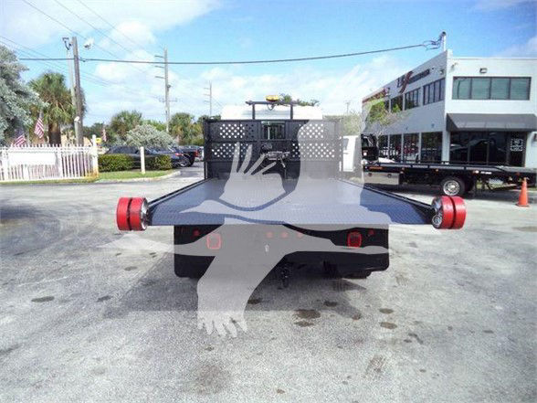 Hino 258LP hooklift truck rear with flatbed arms extended and taillights visible.