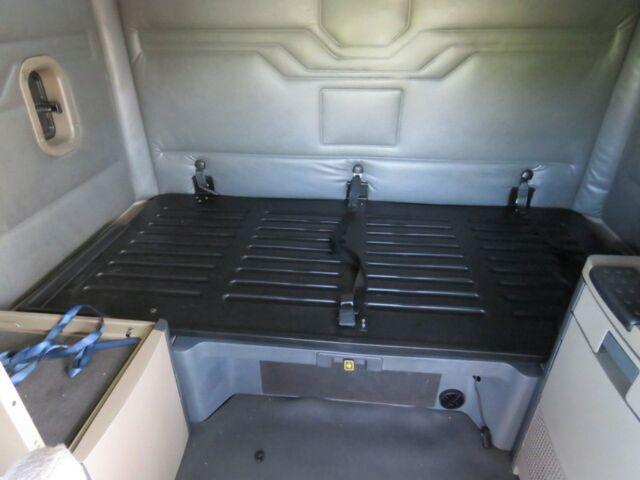 Truck cargo area of a 2016 Freightliner Cascadia Evolution interior with a plastic floor and tie-downs.