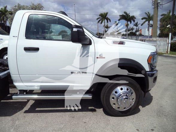 Ram 5500 truck side view showing white cab and front fender with chrome wheel and side step.