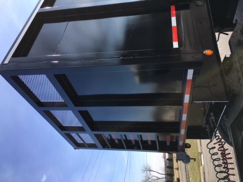 Great Dane single drop trailer side and rear view with black steel frame and reflective safety stripes.
