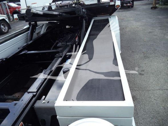 Peterbilt 337 truck bed with hydraulic tow equipment and metal side rail.