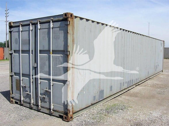 40' used General shipping container with corrugated steel sides, grey exterior, front doors with locking bars, rust on frame corners.