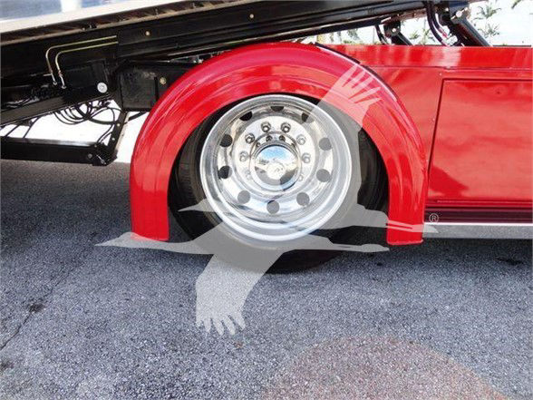 Peterbilt 337 front wheel well showing red fender and polished wheel with chrome lug nuts, undercarriage components visible.