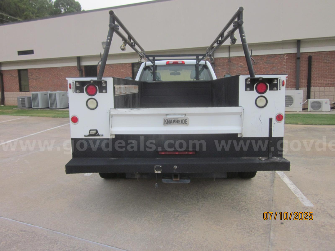 Back view of a white 2017 Chevrolet Silverado 3500HD service/utility truck with a Knapheide flatbed, dual hoists, and rear lights.