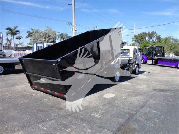 Isuzu NRR dump truck with black dump bed raised, white cab, on dealership lot. on-frame text includes stock number T00085 and VIN JALE5W168D7300085.