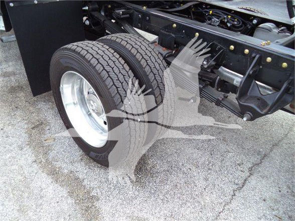 Fleet truck rear dual wheels and chassis showing front suspension, tires, and frame with bolts and components.