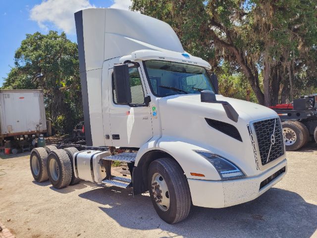 Volvo VNR Daycab tractor showing front and left side with sleeper cab, white exterior, cargo tractor, no trailer attached.