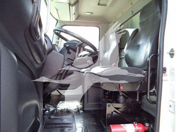 Truck cab interior showing driver's seat and steering wheel in a reefer truck.
