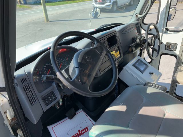 Interior view of a 2006 International 4300 truck cab showing steering wheel, dashboard, and passenger seat.