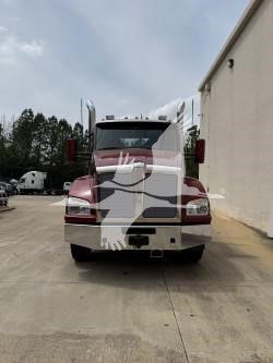 Kenworth T880 truck front view showing large chrome grille, headlights, and upright mirrors.