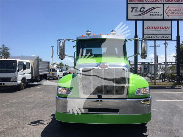 Peterbilt 337 truck front view in lime green color with chrome grille and mirrors.