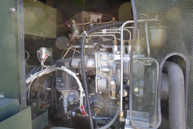 Trucking equipment engine bay with fuel lines, filter, and hoses. Visible text on a filter reads 'BOSCH' and '11 110' and there are various metal components and tubing.