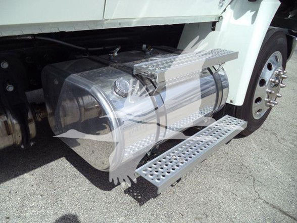 Truck side showing aluminum cylindrical fuel tank and perforated aluminum steps.