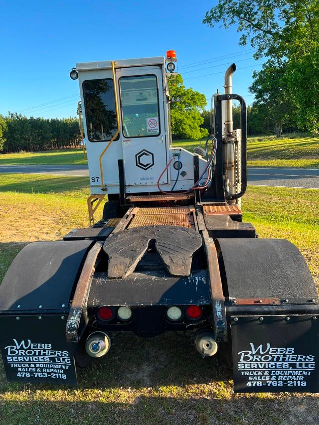 Tractor unit of a capacity TJ5000 yard truck cab rear view showing control cabin with S7 label, back idles, and dual Webb Brothers mud flaps with contact info.