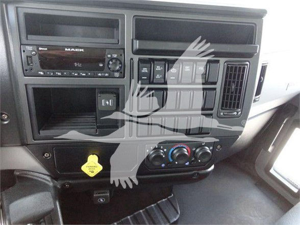 Dashboard of a 2023 Mack MD6 with OEM radio, ventilation panels, switches, and climate controls.