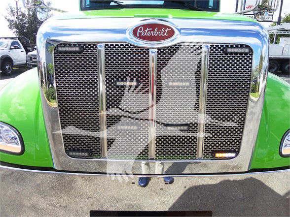 Peterbilt 337 front grille with chrome mesh, green fenders, and Peterbilt emblem on hood
