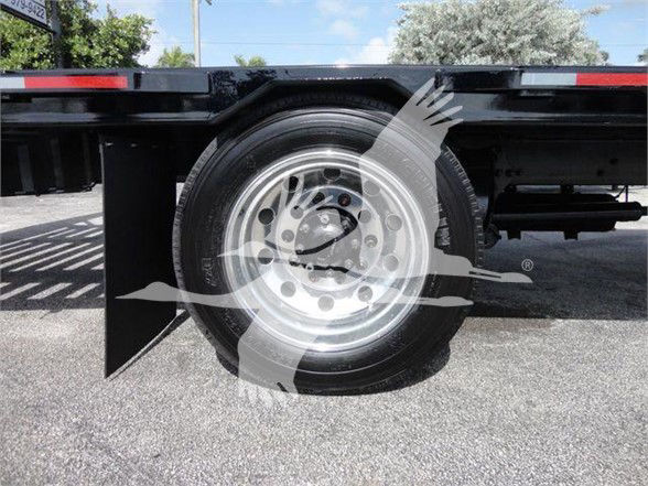 Wheel and tire of a Freightliner Business Class M2 106 trailer truck showing standard steel rim and dual rear axle area; no legible alphanumeric labels visible on the wheel.