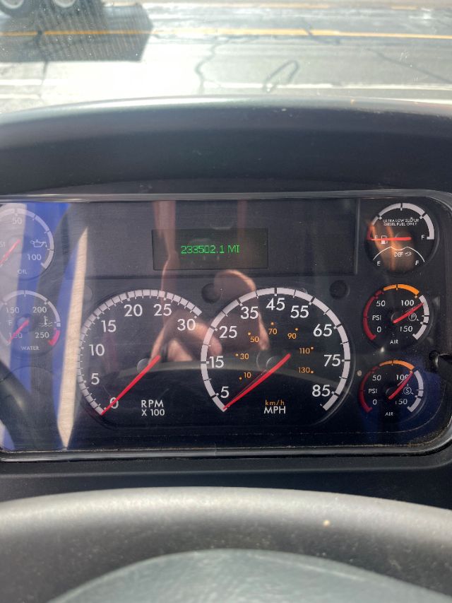 Dashboard of a 2017 Freightliner M2 106 showing rpm gauge, speedometer, and digital odometer reading 235,502.1 miles. Various engine gauges visible.