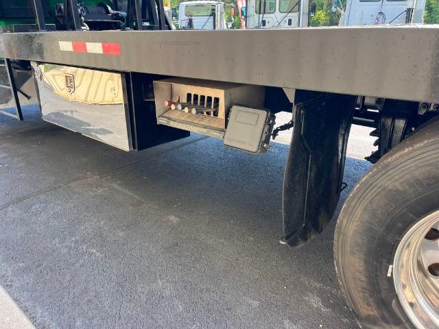 Peterbilt 348 rollback truck rear undercarriage showing electrical connector and storage box under the bed.