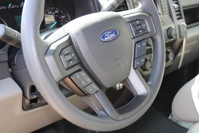 Ford steering wheel with control buttons in a 2022 Ford F-250 service/utility truck interior showing steering column and part of dashboard.