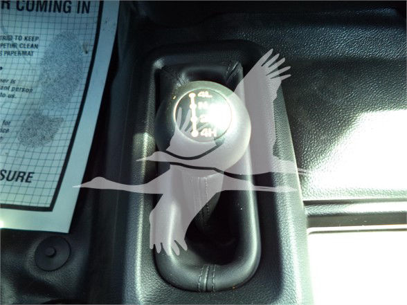 Manual gear shifter knob with 4x4 indicator in Ram 5500 cabin area.