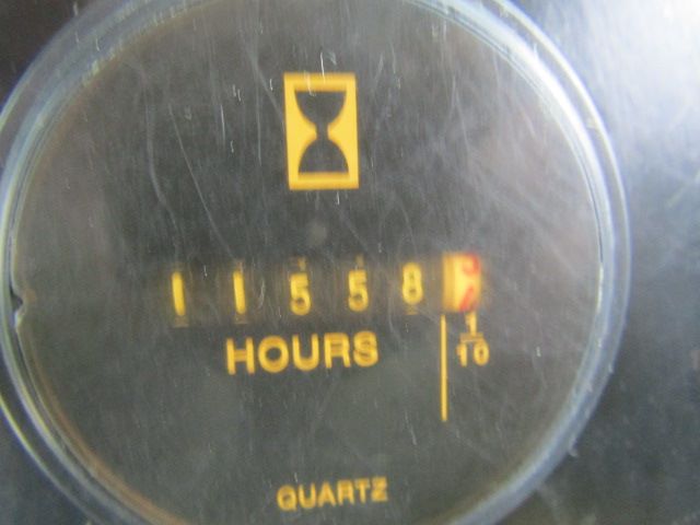 Gauge showing hours meter reading 15585 on Peterbilt 330 identification with quartz label.
